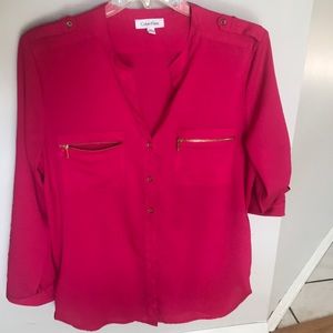 Fish is pink blouse with gold zipper pocket front and gold buttons